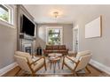 Inviting living room featuring hardwood floors, a cozy fireplace, and lots of natural light at 2925 E 14Th Ave, Denver, CO 80206