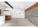 Living room with wood floors and ample natural light from large picture window at 8721 E Cornell Dr, Denver, CO 80231