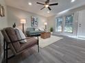Bright living room features large windows, neutral tones, and stylish furnishings at 1250 S Monaco Pkwy # 17, Denver, CO 80224