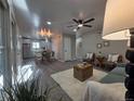 Open-concept living room with modern ceiling fan and plenty of natural light at 1250 S Monaco Pkwy # 17, Denver, CO 80224