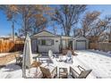 Inviting backyard with outdoor seating, dining area, and detached garage at 2918 Ames St, Wheat Ridge, CO 80214