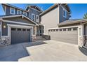 Two-story home with a three-car garage and stone accents at 10774 Chadsworth Ln, Highlands Ranch, CO 80126