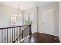 Bright foyer boasts hardwood floors, a staircase with iron railings, and plenty of natural light at 13275 E Caley Pl, Centennial, CO 80111