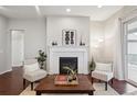 Cozy living room featuring a fireplace, stylish decor, and an inviting atmosphere at 13275 E Caley Pl, Centennial, CO 80111