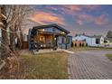 Lovely exterior view of home with covered porch, stone driveway and manicured landscaping at 4510 W 4Th Ave, Denver, CO 80219