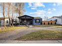Inviting home with covered front porch, beautiful brick driveway and manicured lawn at 4510 W 4Th Ave, Denver, CO 80219