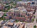 An aerial view showing the urban neighborhood of the residence with many brown brick buildings at 1499 Blake St # 3U, Denver, CO 80202
