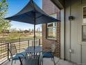 Charming patio with outdoor seating, offering a relaxing space with lovely landscape views at 5004 S Platte River Pkwy, Littleton, CO 80123