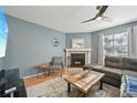 Comfortable living room with modern ceiling fan and decorative brick fireplace at 12655 E Pacific Cir # C, Aurora, CO 80014
