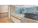 Open-concept living space featuring wood floors and a breakfast bar at 12655 E Pacific Cir # C, Aurora, CO 80014