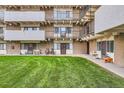 Apartment exterior featuring multiple balconies, lawn area, and walkways at 384 S Ironton St # 208, Aurora, CO 80012