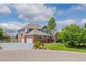 Charming brick home with a well-manicured lawn and mature trees at 7119 S Riviera St, Aurora, CO 80016