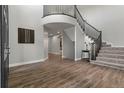Spacious foyer featuring hardwood floors and staircase with iron railing at 7119 S Riviera St, Aurora, CO 80016
