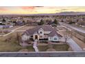 Expansive aerial view of the large stucco home with lush landscaping in a desirable neighborhood at 16394 W 77Th Ln, Arvada, CO 80007