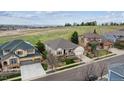 Panoramic aerial view of a home nestled in a neighborhood with expansive green space and scenic mountain views at 7450 S Lee Way, Littleton, CO 80127