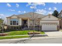 Inviting single-story home with a well-maintained lawn and charming stone accents creating curb appeal at 7450 S Lee Way, Littleton, CO 80127