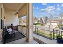 Cozy front porch featuring comfortable seating and a view of a peaceful street, perfect for relaxing at 7450 S Lee Way, Littleton, CO 80127