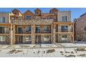 Three-story townhouses with stone and wood accents; modern mountain style at 9656 Browns Peak Cir, Littleton, CO 80125