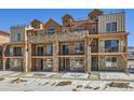 Three-story townhouses with stone and wood accents; modern mountain style at 9656 Browns Peak Cir, Littleton, CO 80125