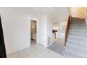 Open living space featuring tile flooring, carpeted stairs, and bathroom at 9925 W 20Th Ave # 2, Lakewood, CO 80215
