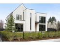 Modern home with a unique architectural design and black framed windows and landscaping at 1001 S Adams St, Denver, CO 80209