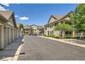 Community street view with garages and condo buildings, showcasing a well-kept neighborhood at 4385 S Balsam St # 6-103, Littleton, CO 80123