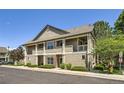 Well-maintained condo exterior featuring stone accents and private balcony at 4385 S Balsam St # 6-103, Littleton, CO 80123