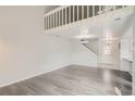 Spacious living room with light gray wood flooring and staircase to loft at 13504 E Asbury Dr, Aurora, CO 80014