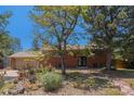 Charming brick home with well-maintained front yard featuring colorful landscaping at 15 Pawnee Dr, Boulder, CO 80303