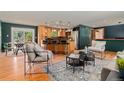 Inviting living room with wood floors open to a modern kitchen with stainless appliances at 15 Pawnee Dr, Boulder, CO 80303