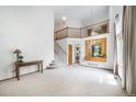 Spacious living room with staircase and views to the kitchen at 20738 E Grand Pl, Aurora, CO 80015