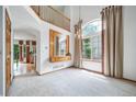 Open-concept living room with decorative chandelier and large window at 20738 E Grand Pl, Aurora, CO 80015