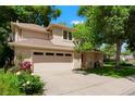 Lovely two-story home showcasing a two-car garage, mature trees, and a well-manicured lawn, creating a welcoming curb appeal at 5530 Racquet Ln, Boulder, CO 80303