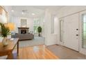 Bright living room featuring a fireplace, high ceilings, neutral decor, and an open entryway, perfect for relaxation and entertaining at 5530 Racquet Ln, Boulder, CO 80303