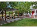 Outdoor pergola area offers a communal gathering space with a large wooden table and benches perfect for neighborhood events at 8171 E 33Rd Ave, Denver, CO 80238