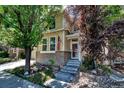 Charming two-story home with brick accents, an American flag, and stone landscaping at 10609 Abilene St, Commerce City, CO 80022