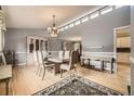 Elegant dining room with hardwood floors, a chandelier, and lots of natural light at 6072 Pierson Ct, Arvada, CO 80004
