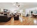 Open concept living room features a brick fireplace, hardwood floors, and lots of natural light at 3298 S Krameria St, Denver, CO 80222