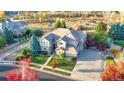 Aerial view of home with a well-manicured lawn, mature trees and multi-car driveway at 15723 E Orchard Pl, Aurora, CO 80016