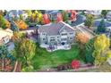 Aerial view of home showcasing a landscaped backyard, patio, and its location in a lush neighborhood at 15723 E Orchard Pl, Aurora, CO 80016