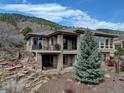 Beautiful backyard featuring a stone patio, landscaping, and a private outdoor living space at 5951 Rain Dance Trl, Littleton, CO 80125