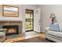 Inviting living room with a fireplace, tile floors, and natural light streaming through the front door at 7761 S Curtice Dr # C, Littleton, CO 80120
