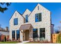 Elegant stone home with a copper awning over the arched front door at 2365 S Clayton St, Denver, CO 80210