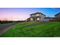 Charming two-story home featuring well-kept front yard and covered front porch at 11677 Park South Ln, Parker, CO 80138