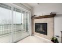 Cozy fireplace with mantle and a balcony with sliding glass door at 804 Summer Hawk Dr # 303, Longmont, CO 80504