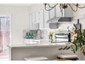 Bright kitchen featuring sleek countertops, stainless steel appliances, and barstool seating at 7050 W Cedar Ave # 108, Lakewood, CO 80226