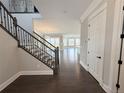 Inviting foyer with hardwood floors and a staircase leading to the upper level, providing a warm welcome at 6023 Chester Way, Denver, CO 80238