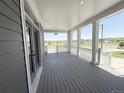 Expansive covered porch offers plenty of room for outdoor seating with scenic views of the neighborhood at 6023 Chester Way, Denver, CO 80238