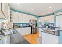 Bright kitchen with white cabinets, stainless steel appliances, and granite countertops at 24022 E Jamison Dr, Aurora, CO 80016