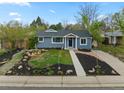 Charming home featuring a well-manicured front yard and inviting curb appeal at 835 S Shoshone St, Denver, CO 80223